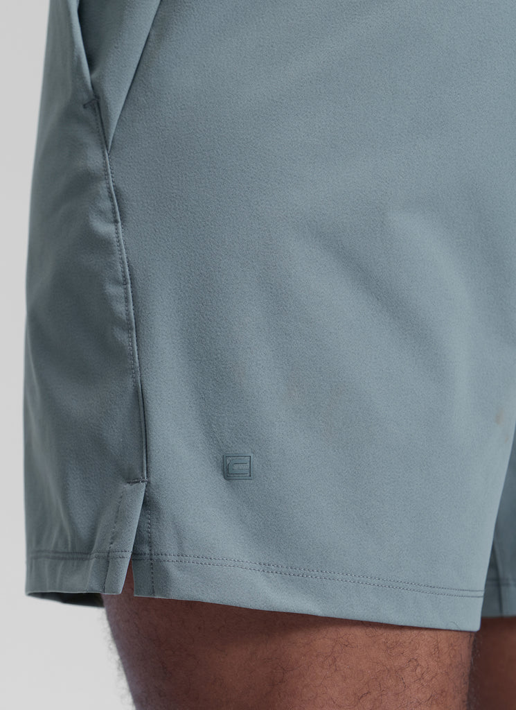 CRZ YOGA Men's Workout Classic FIt Quick Dry Pocket Shorts  7" Mojave Tan